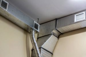 istockphoto-1081655968-612×612 Industrial air duct ventilation equipment and pipe systems installed on industrial building ceiling.