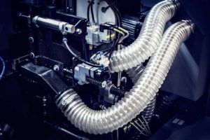 Flexible reinforced plastic hoses on a machine Flexible reinforced plastic hoses on a machine